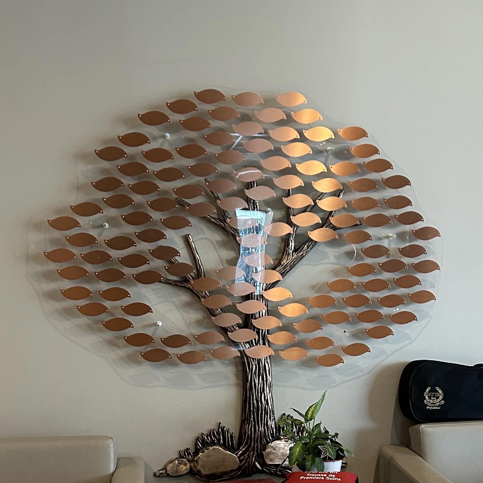 I saw this artwork at my church. The leaves appear to be made of copper and attached to acrylic. I'm not entirly sure what the base of the tree is made out of.
